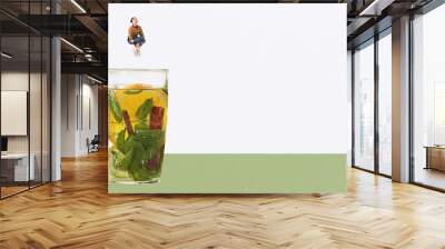 Contemporary art collage. Creative design. Young woman jumping into cup with mint tea with lemons and cinnamon. Tasty vitamin drink Wall mural