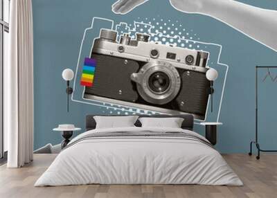 Contemporary art collage. Human hands holding retro camera isolated over blue backgroud. LGBTQIA support Wall mural