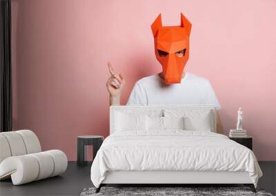 Creative portrait of young man in white t-shirt with cardboard animal mask on his head isolated on pink background. Concept of art, fashion, theater, funny meme emotions. Wall mural