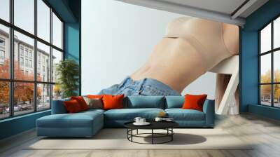 Cropped image of slender female body, breast and belly isolated over grey studio background Wall mural