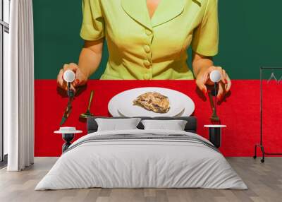 Cropped image of woman eating oyster on red tablecloth isolated over green background Wall mural