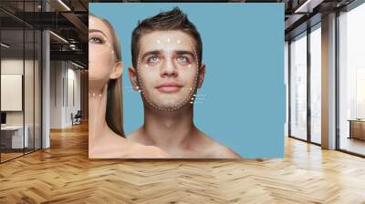 Face lifting, circuit. Young man and woman with arrows on face symbolling face lifting effects with cosmetological treatment. Concept of skincare, natural beauty, plastic surgery, health, cosmetics Wall mural