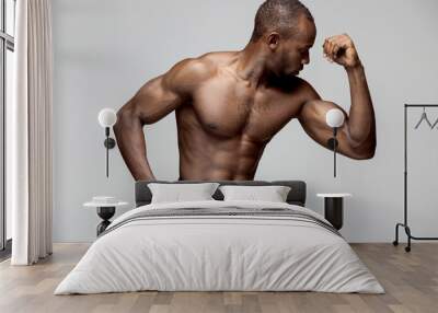 Fit young man with beautiful torso, isolated on gray background. The naked torso of African American man posing at studio. The muscular body, fitness, sports, healthy lifestyle and bodybuilder concept Wall mural