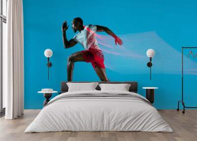 full length portrait of active young muscular running man, Wall mural