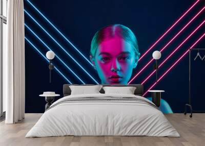 Future. Portrait of female fashion model in neon light with neoned blue glowing lines on dark studio background. Beautiful woman with trendy make-up and well-kept skin. Vivid style, beauty concept. Wall mural