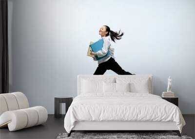 Getting faster and stronger. Happy woman working at office, jumping and dancing in casual clothes or suit isolated on white studio background. Business, start-up, working open-space concept. Wall mural