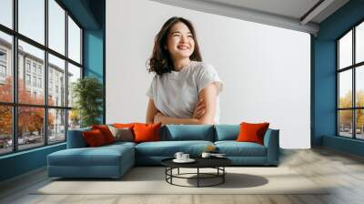 Happy asian woman standing and smiling isolated on gray studio background. Beautiful female half-length portrait. Young emotional woman. The human emotions, facial expression concept. Wall mural