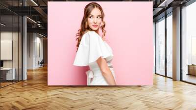 Happy business woman standing and smiling isolated on pink studio background. Beautiful female half-length portrait. Young emotional woman. The human emotions, facial expression concept Wall mural