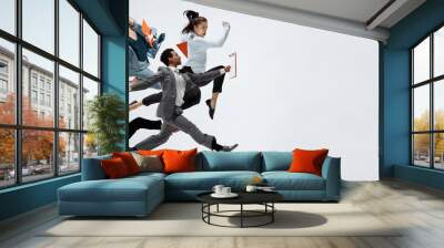 Happy business women and african man dancing isolated on white. Wall mural