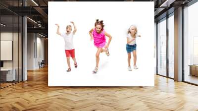 Happy children, little and emotional caucasian kids jumping and running isolated on white background. Looks happy, cheerful, sincere. Copyspace for ad. Childhood, education, happiness concept. Wall mural