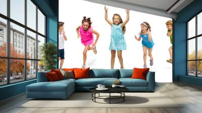 Happy children, little and emotional caucasian kids jumping and running isolated on white background. Looks happy, cheerful, sincere. Copyspace for ad. Childhood, education, happiness concept. Wall mural