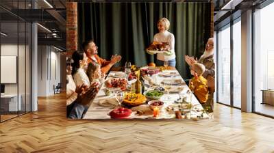 Happy Thanksgiving dinner party with family and friends with turkey and holiday traditional food, dishes on table. Wall mural