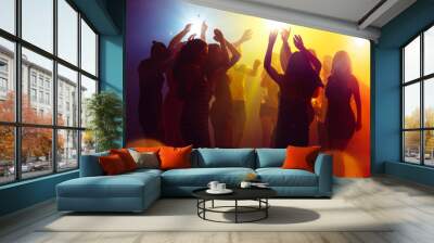 Holidays. A crowd of people in silhouette raises their hands on dancefloor on neon light background. Night life, club, music, dance, motion, youth. Yellow-blue colors and moving girls and boys. Wall mural