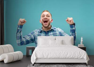 I won. Winning success happy man celebrating being a winner. Dynamic image of caucasian male model on blue studio background. Victory, delight concept. Human facial emotions concept. Trendy colors Wall mural