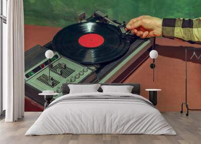 Image of old-fashioned vintage vinyl record player isolated over dark green background Wall mural