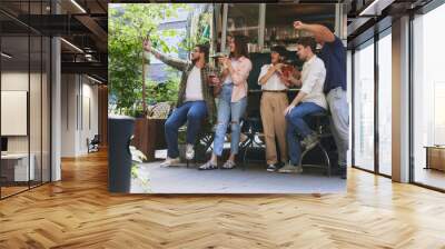 Joyful people, friends, men and women meeting at local outdoor bar, clinking beer glasses and taking selfie with mobile phone. Cozy memories. Concept of relaxation, party, beer, festival, celebration Wall mural