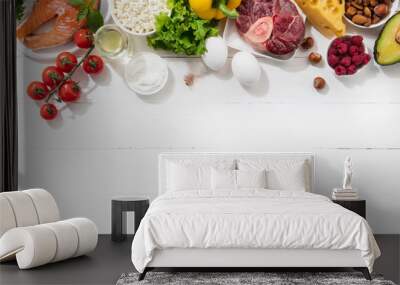 Ketogenic low carbs diet - food selection on white background. Balanced healthy organic ingredients of high content of fats for the heart and blood vessels. Meat, fish and vegetables. Copyspace. Wall mural