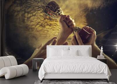 Leader way. Award of victory, male hands tightening the golden cup of winners against cloudy dark sky. Sport, competition, championship, winning, achieving the goal. Prize for success and honor. Wall mural