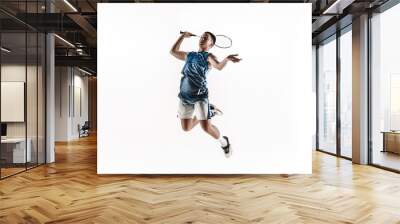 Little boy playing badminton isolated on white studio background. Young male model in sportwear and sneakers with the racket in action, motion in game. Concept of sport, movement, healthy lifestyle. Wall mural