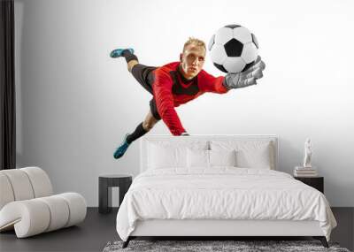 male soccer player goalkeeper catching ball in jump. silhouette of fit man with ball isolated on whi Wall mural