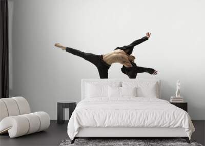 Man in casual style clothes jumping and dancing isolated on white background. Art, motion, action, flexibility, inspiration concept. Flexible caucasian ballet dancer. Wall mural