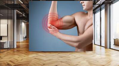 Man With Pain In Elbow. Pain relief concept Wall mural