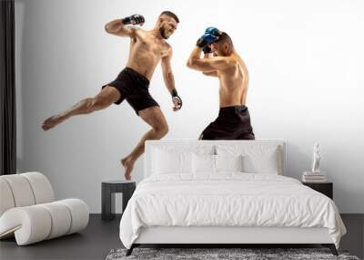 MMA. Two professional fightesr punching or boxing isolated on white studio background. Couple of fit muscular caucasian athletes or boxers fighting. Sport, competition, excitement and human emotions Wall mural