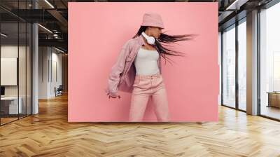 Monochrome portrait of young attractive happy woman in casual style outfit isolated on pink background. Concept of beauty, art, fashion, youth, style Wall mural