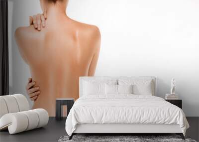 Naked back of a woman, isolated on white background Wall mural