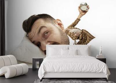 No time for breakfest again. Big head on small body lying on the pillow. Man in home suit holding alarm cannot wake up 'cause headache and overslept. Concept of business, working, time limits. Wall mural