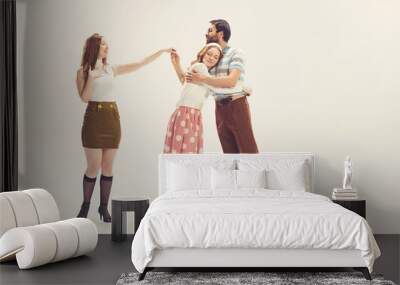 One young man and two girl in vintage retro style outfits psoing isolated on white background. Concept of relationships, family, 1960s american fashion style and art. Wall mural