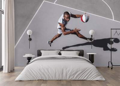 Picture of young confused african basketball player practicing outdoor. Fit afro man in motion and movement. athletic and sport lifestyle concept. Top view Wall mural