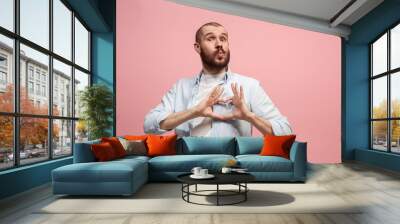 Portrait of attractive man with kiss isolated over pink background Wall mural