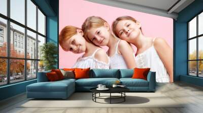 Portrait of beautiful little girls, children posing together against pink studio background. Well-being, care free time. Concept of skincare, childhood, cosmetology and health, beauty, ad Wall mural