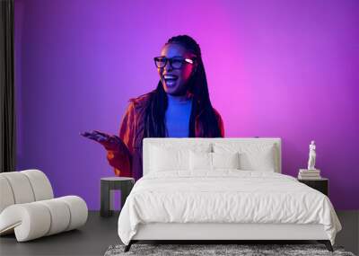 Portrait of female fashion model in cotton shirt isolated on purple background in neon light. Concept of beauty, art, fashion, youth and emotions Wall mural