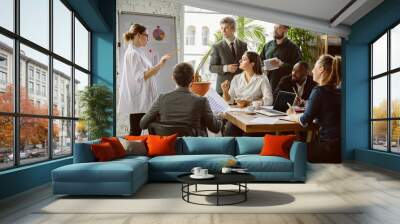 Pride. Group of young business professionals having a meeting. Diverse group of coworkers discuss new decisions, plans, results, strategy. Creativity, workplace, business, finance, teamwork. Wall mural