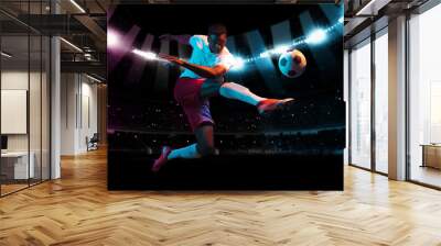 Professional football or soccer player in action on stadium with flashlights, kicking ball for winning goal. Concept of sport, competition, motion, overcoming. Wall mural