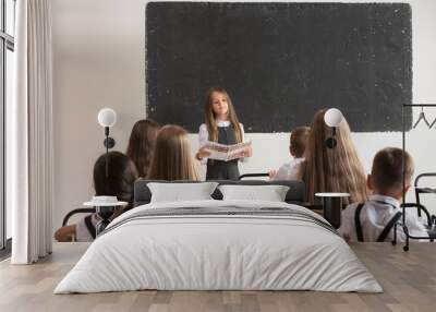 School children in classroom at lesson. The little boys and girls sitting at desks. Back to school, education, classroom, lesson, learn, lifestyle, childhood concept Wall mural