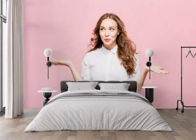 Surprised happy beautiful woman looking in excitement. Studio shot on pink background Wall mural