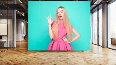 The beautiful young woman in pink mini dress posing at studio Wall mural