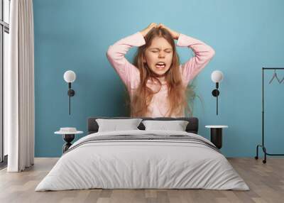 The cry. Teen girl on a blue background. Facial expressions and people emotions concept Wall mural