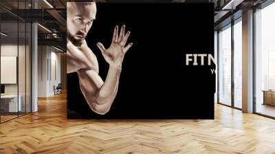 The fit man doing weight lifting in gym on black background. The fitness, training, sport, workout, exercise, athlete, healthy lifestyle concept Wall mural