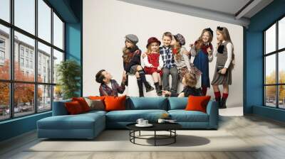 The group of beautiful girls and boys on a pastel background Wall mural