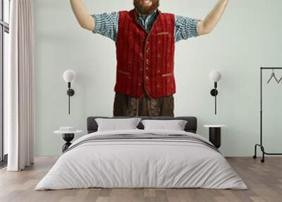 The happy smiling friendly man dressed like a funny gnome or elf posing on an isolated gray studio background. The winter, holiday, christmas concept Wall mural