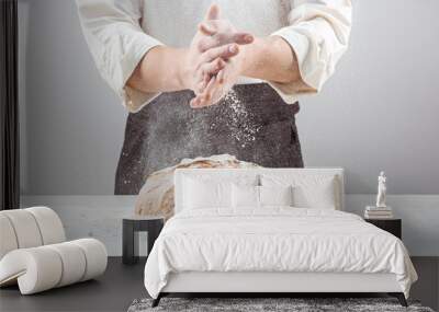 The male hands in flour and rustic organic loaf of bread Wall mural