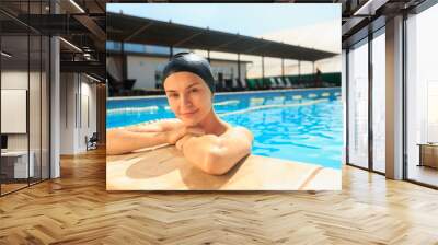 The portrait of happy smiling beautiful woman at the swimming pool. Female caucasian model at blue wate. Pool, leisure, swimming, summer, recreation, healthy lifstyle concept Wall mural