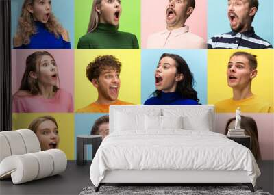 The surprised and astonished young woman and man screaming with open mouth isolated on colorful background. concept of shock face human emotion Wall mural