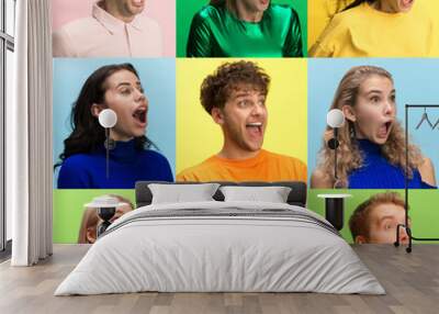 The surprised and astonished young woman and man screaming with open mouth isolated on colorful background. concept of shock face human emotion Wall mural