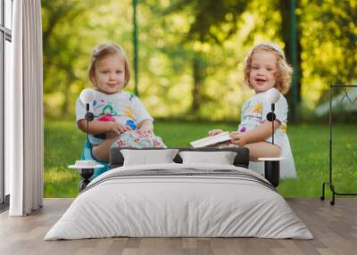 The two little baby girls sitting on pots Wall mural