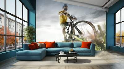 The young fit men in helmet conquering mountains on a bicycle. The bike, nature, bicycle, sport, cycle, extreme, lifestyle, adventure and sport concept Wall mural